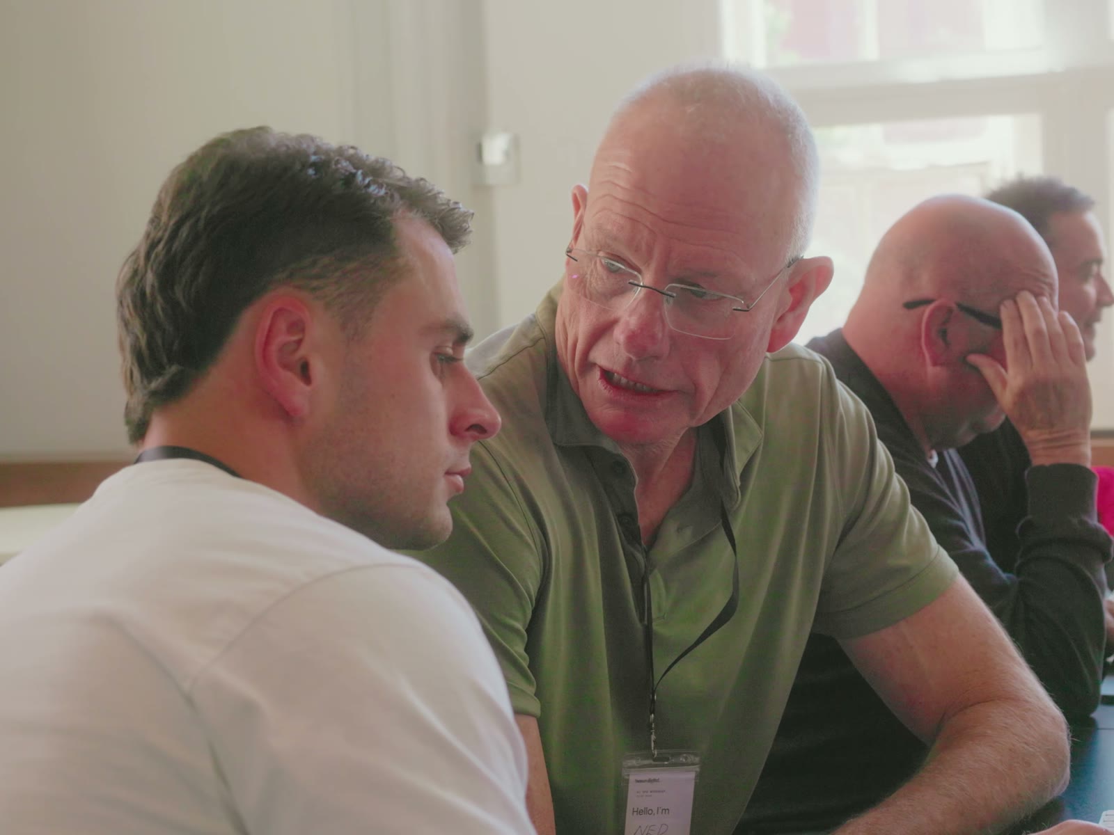 A table of attendees working together